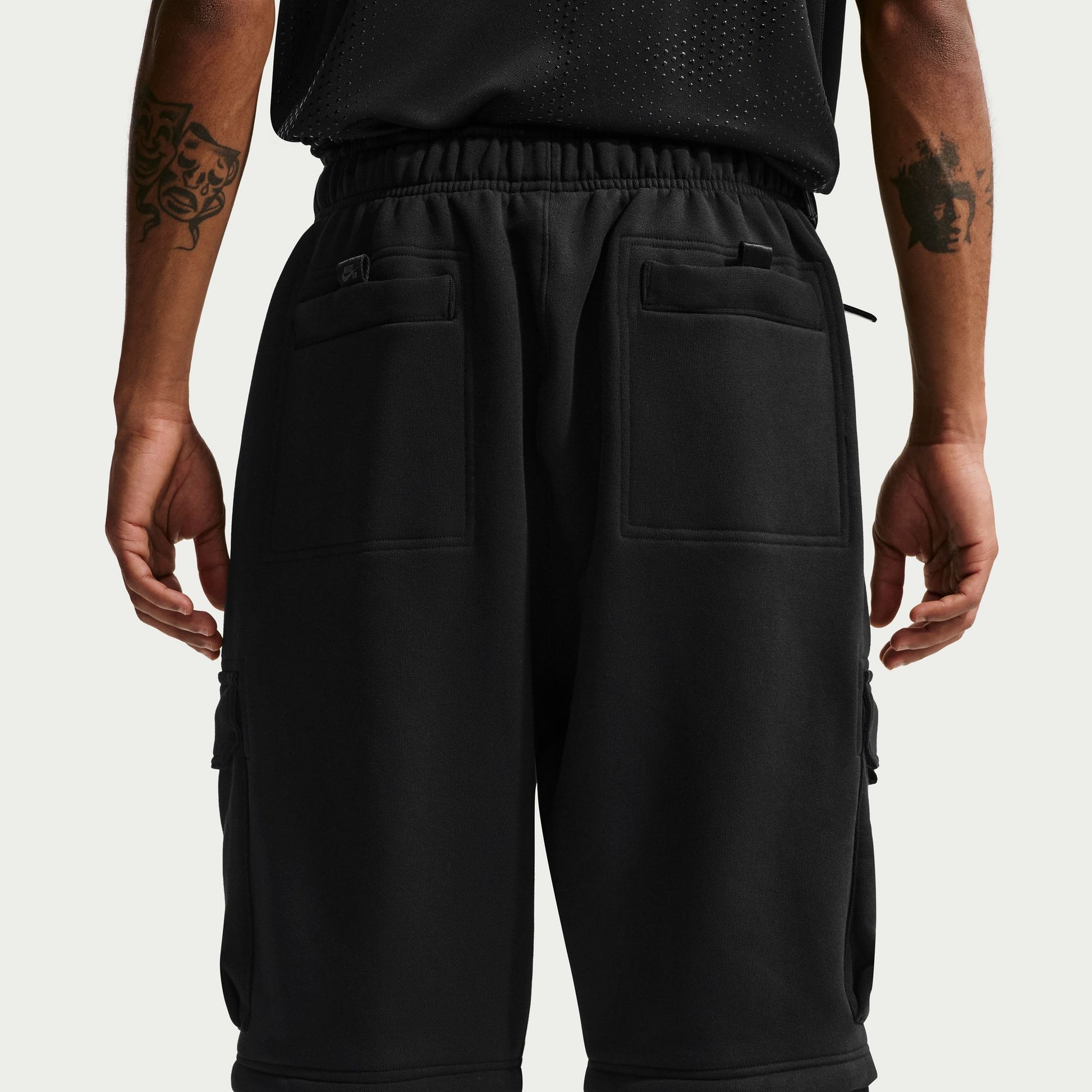 Black cargo pants worn by a person on a light gray background