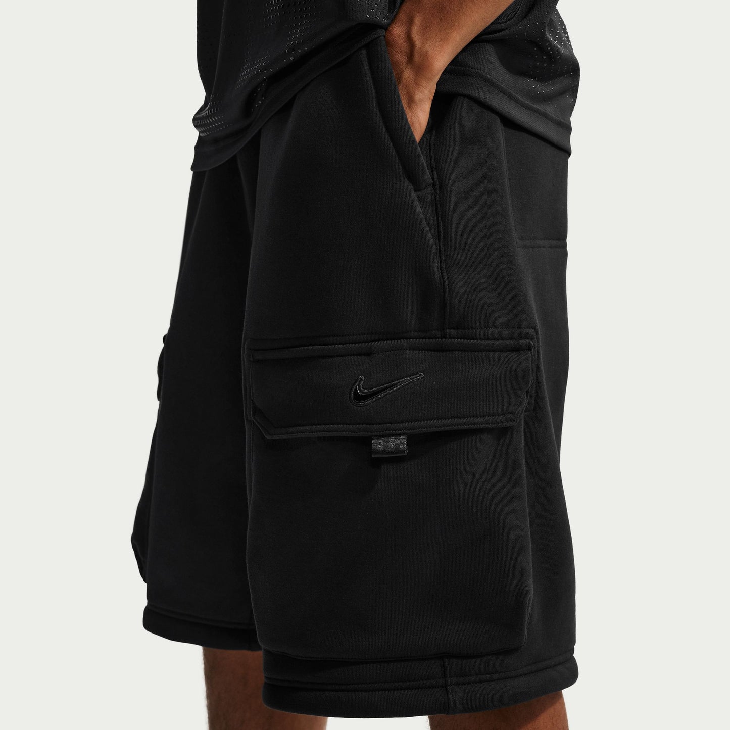 Black shorts with a Nike logo on a light gray background