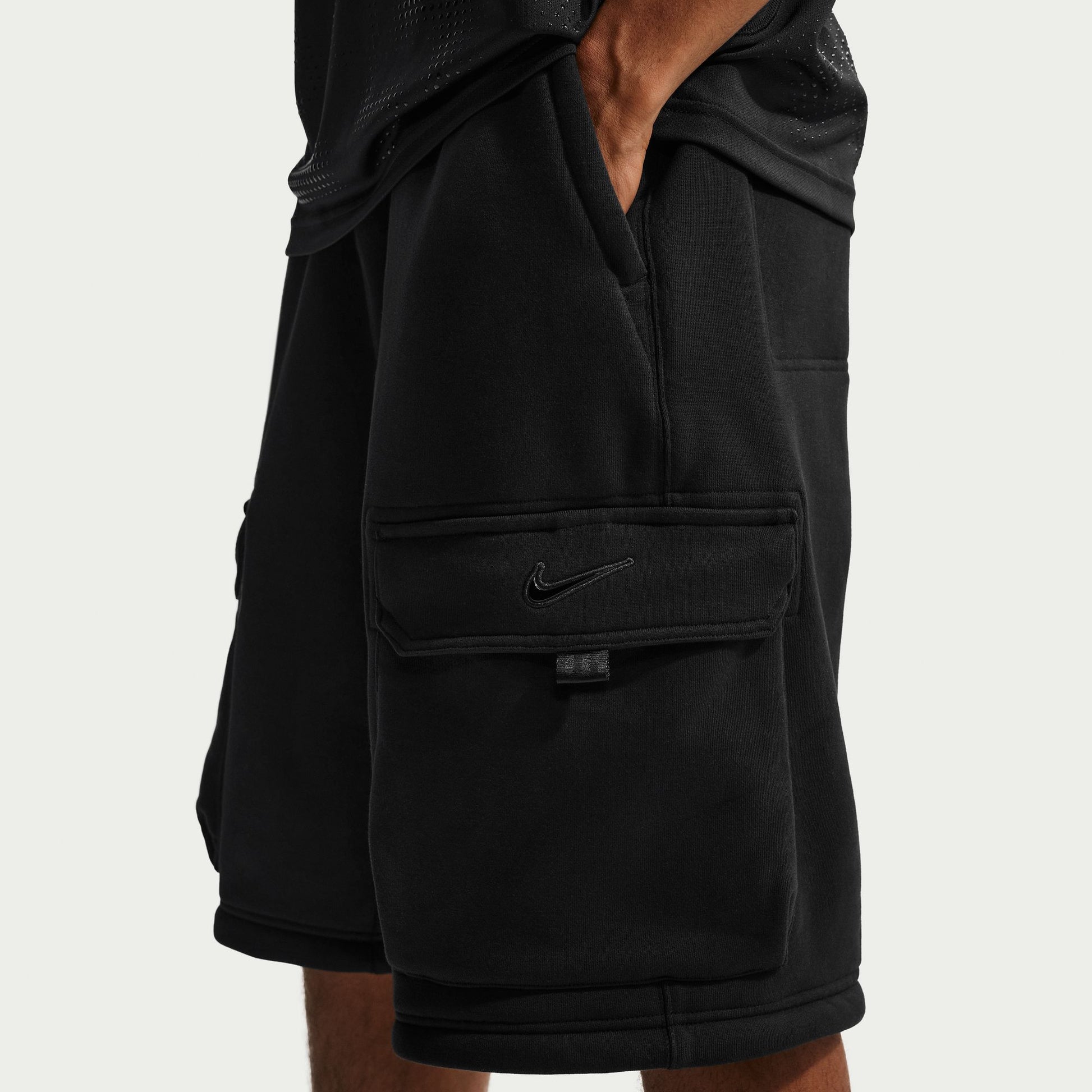 Black shorts with a Nike logo on a light gray background