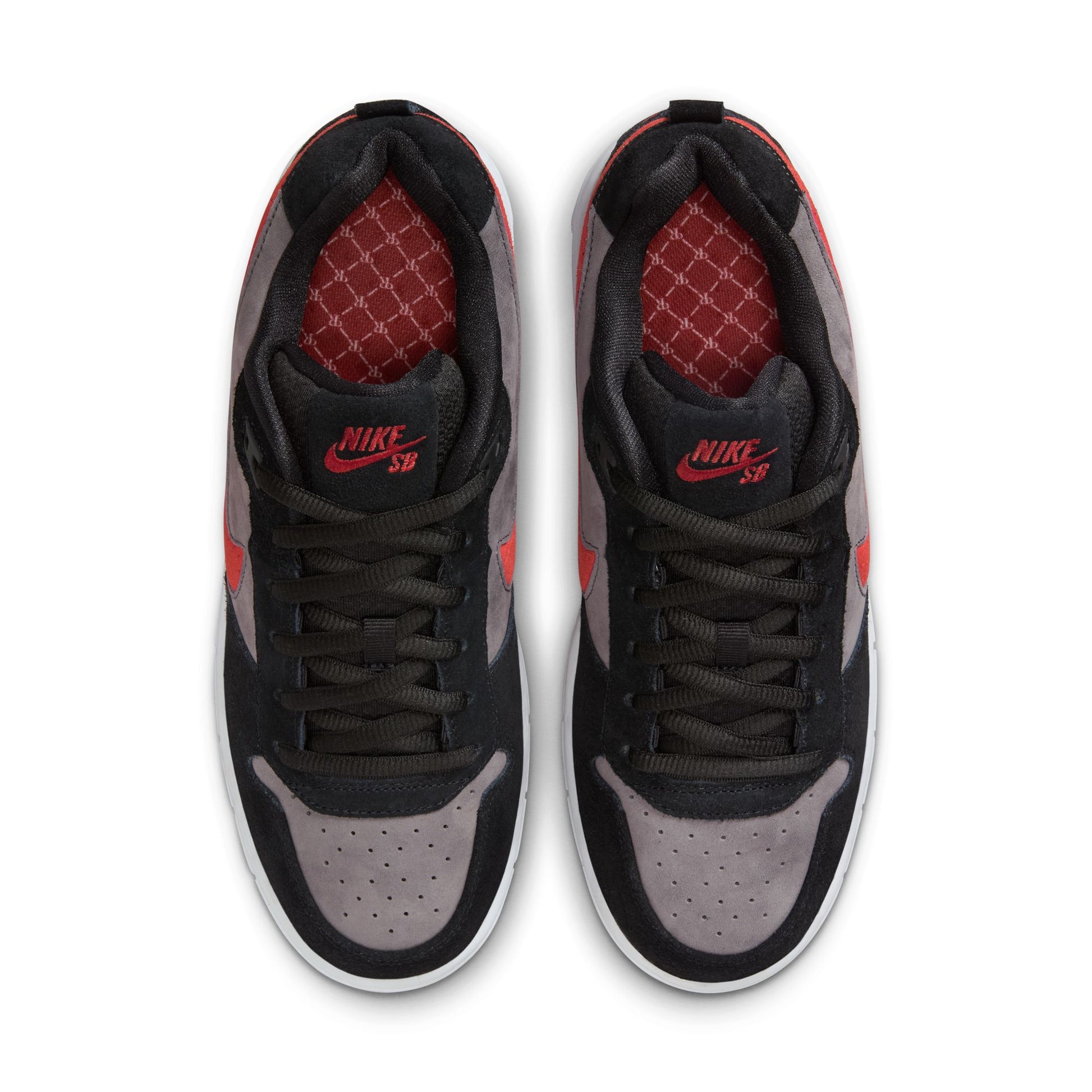 Top view of black and gray sneakers with red accents on a white background