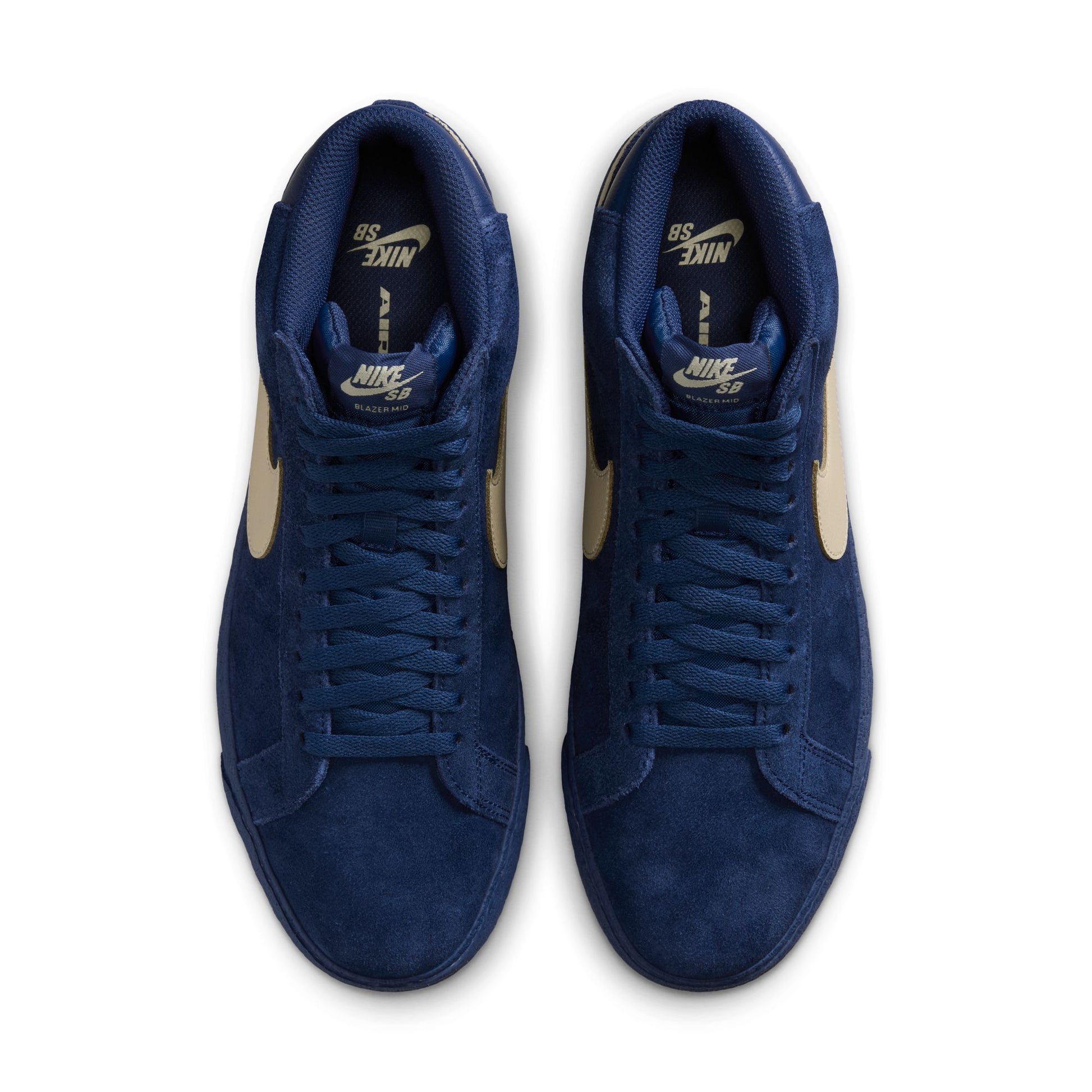 Pair of blue Nike SB sneakers on a white background, photo taken from above