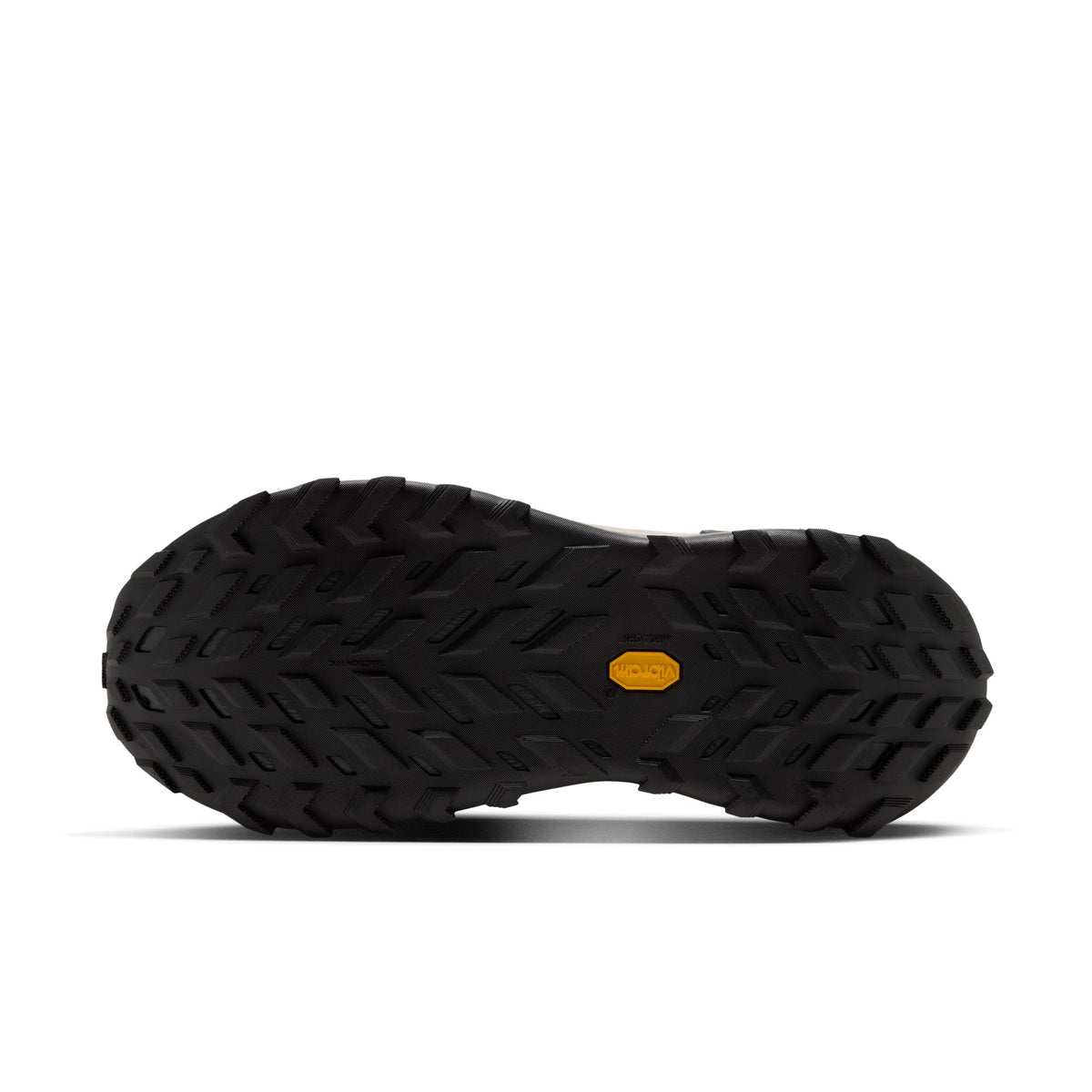 A close-up, bottom view of a black rugged shoe sole with a small yellow Vibram logo in the center, set against a plain white background.
