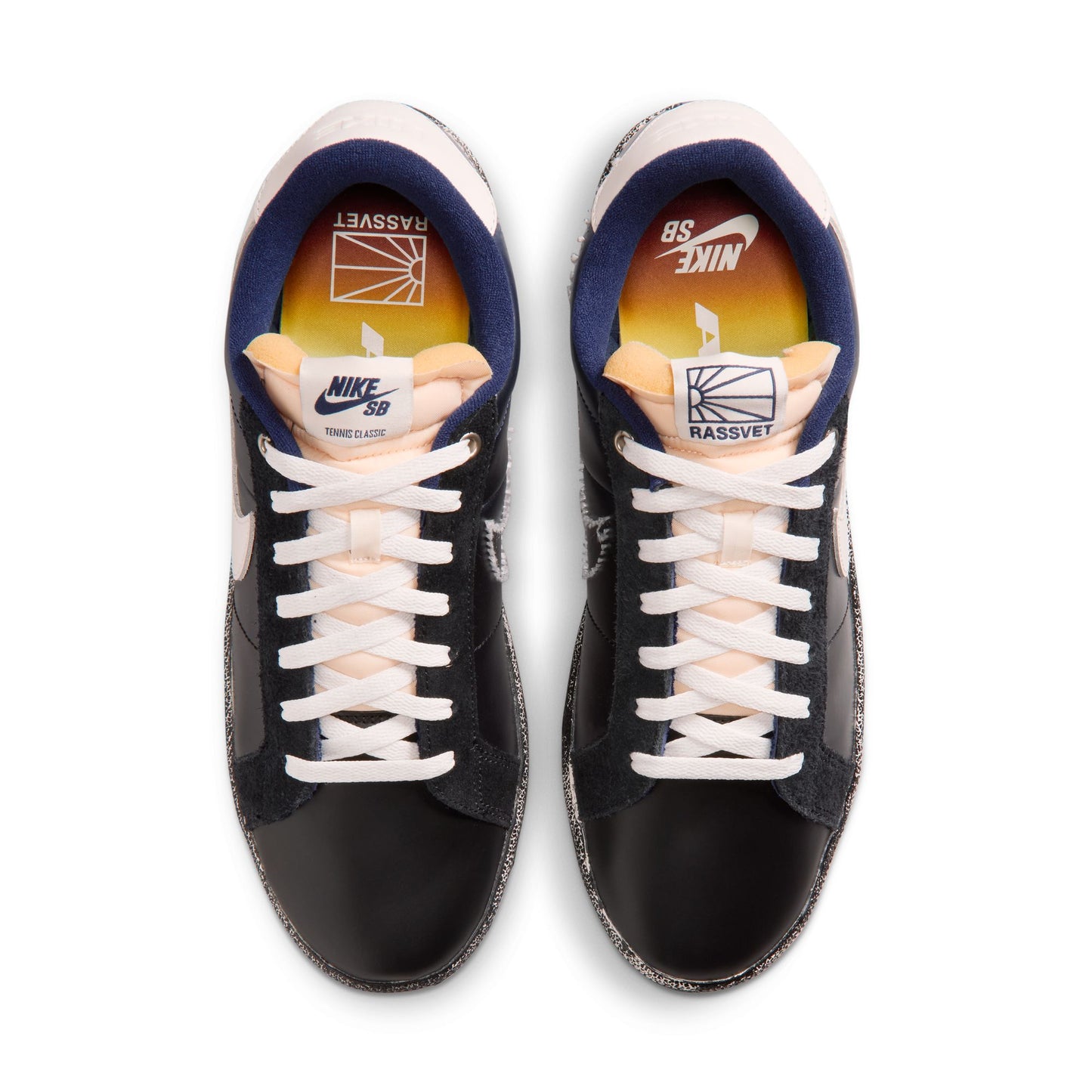 overhead view of Black sneakers with white laces on a white background
