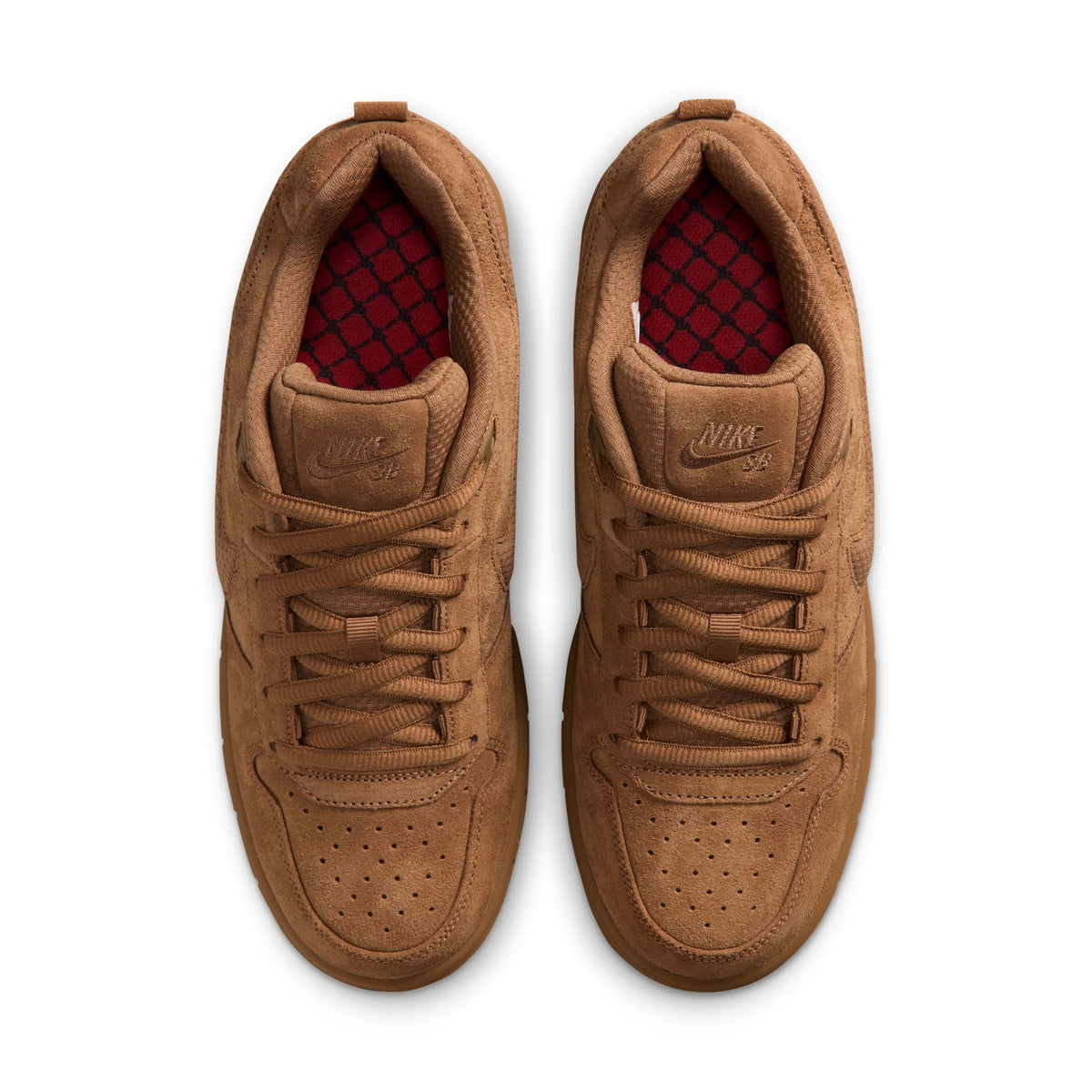 A pair of Nike sb paul rodriguez sneakers in a monochromatic tan/brown suede and leather upper, featuring a red patterned lining visible inside the collar, shown from a top-down view on a white background.