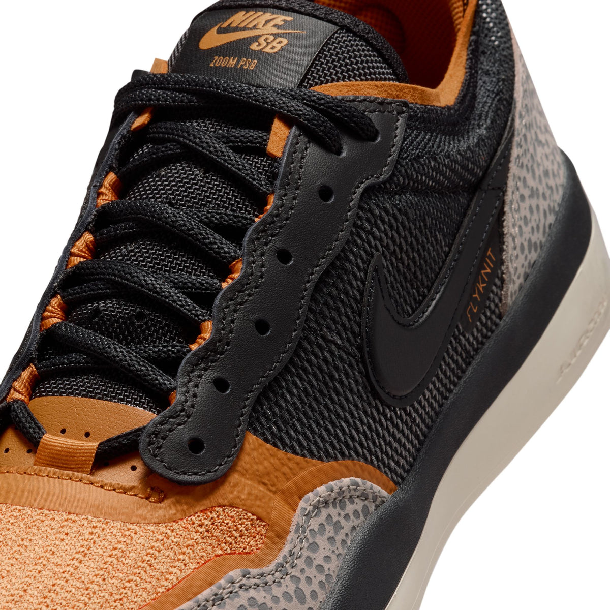 Close-up of a Nike SB sneaker with black, brown, and gray design on a white background
