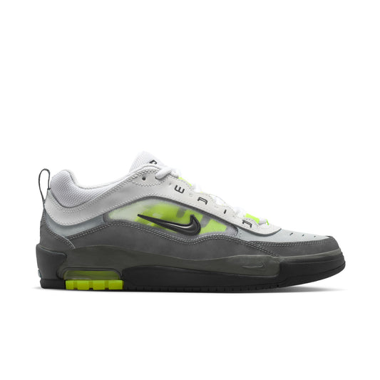 Gray and black sneaker with neon green accents on a white background