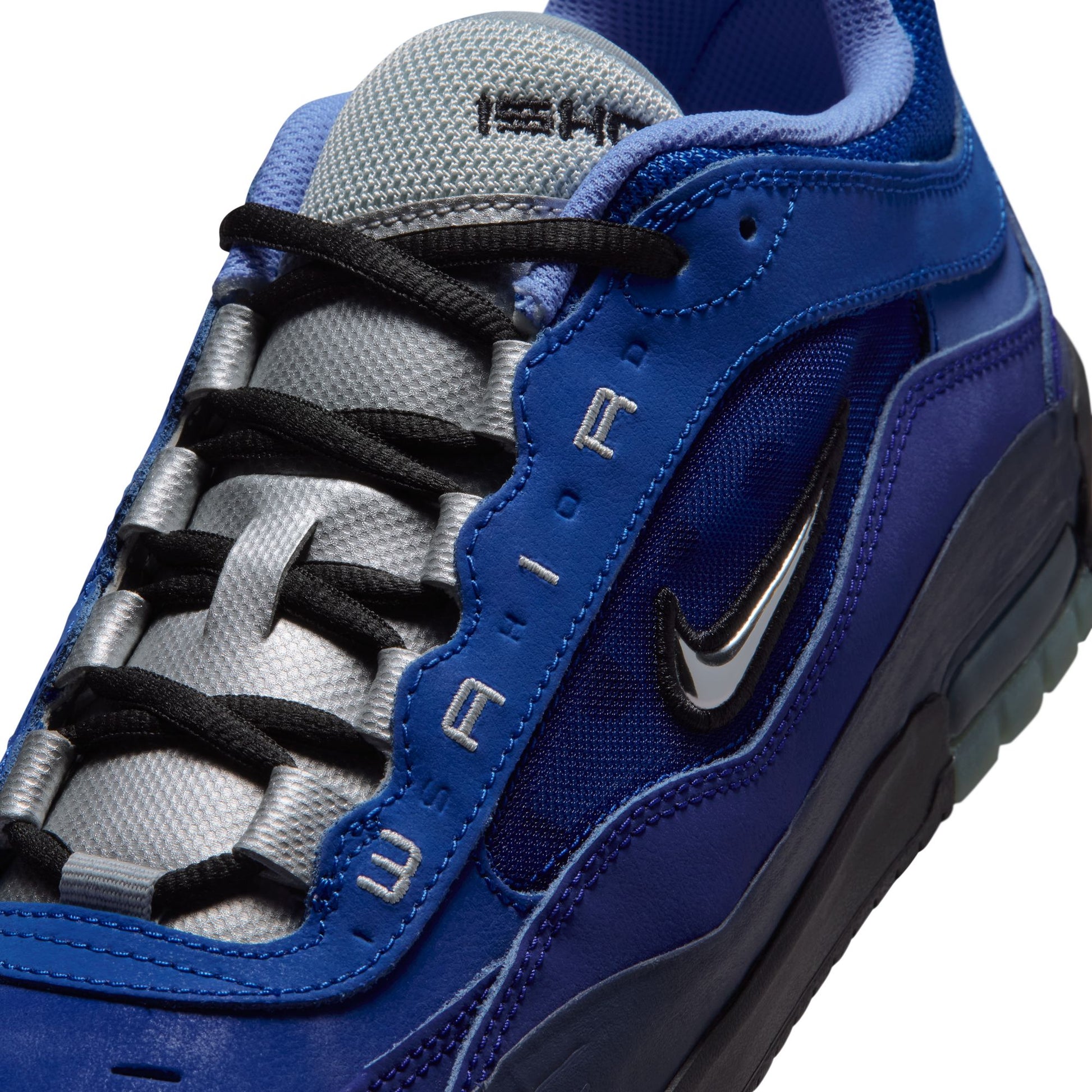 Blue and gray sneaker with black laces on a white background