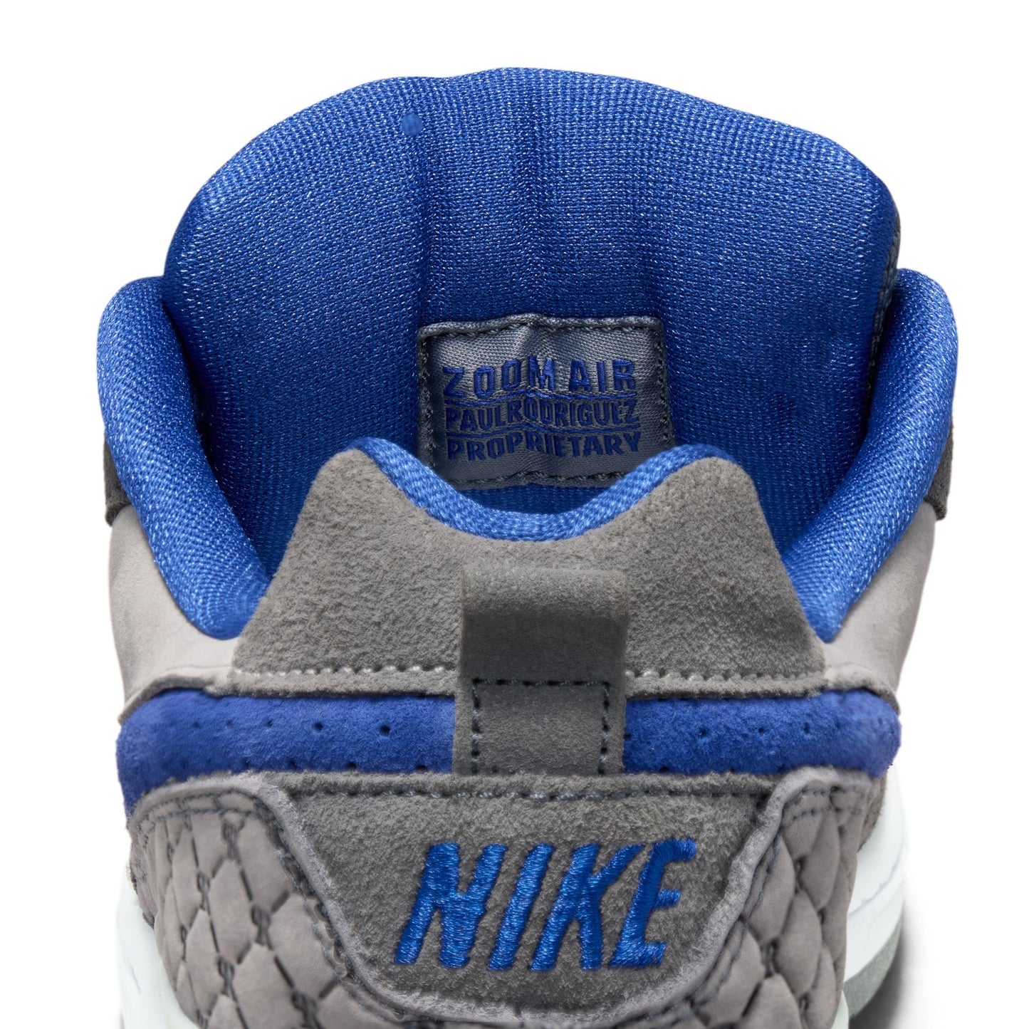 Close-up of a Nike shoe with blue and gray design on a white background