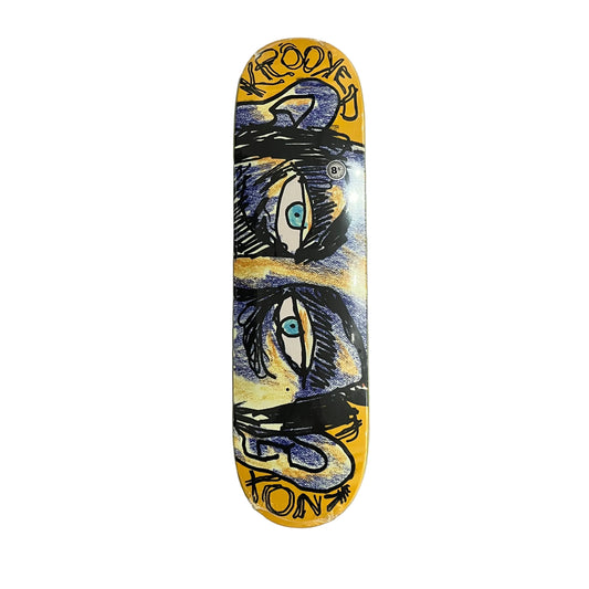 A skateboard deck featuring a yellow background with a stylized graphic of two eyes and the text 'KROOKED' and 'KNOX', photographed flat on a white surface.