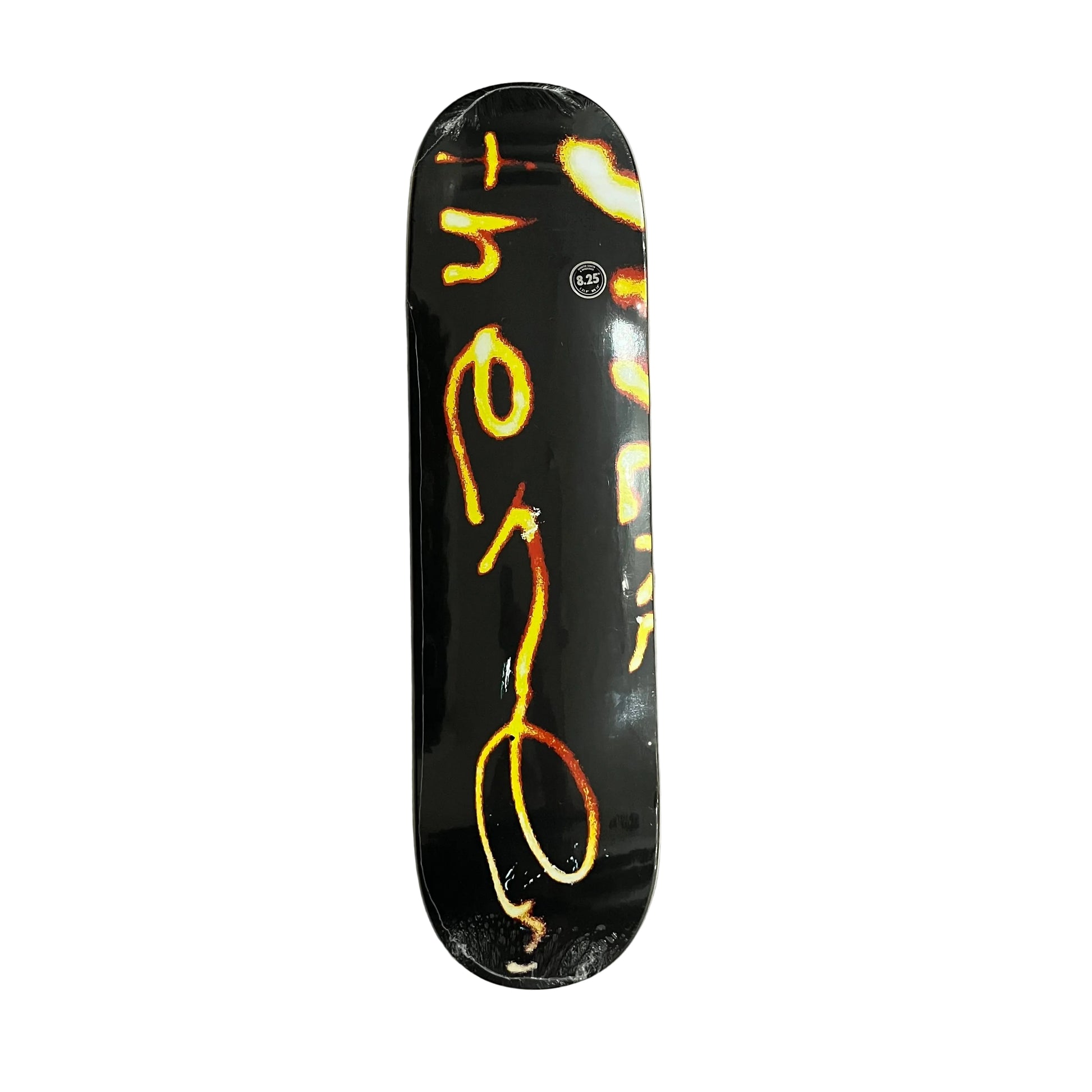 A skateboard deck with a black background and a vertical There graphic in yellow, orange, and red, photographed from above on a white surface.