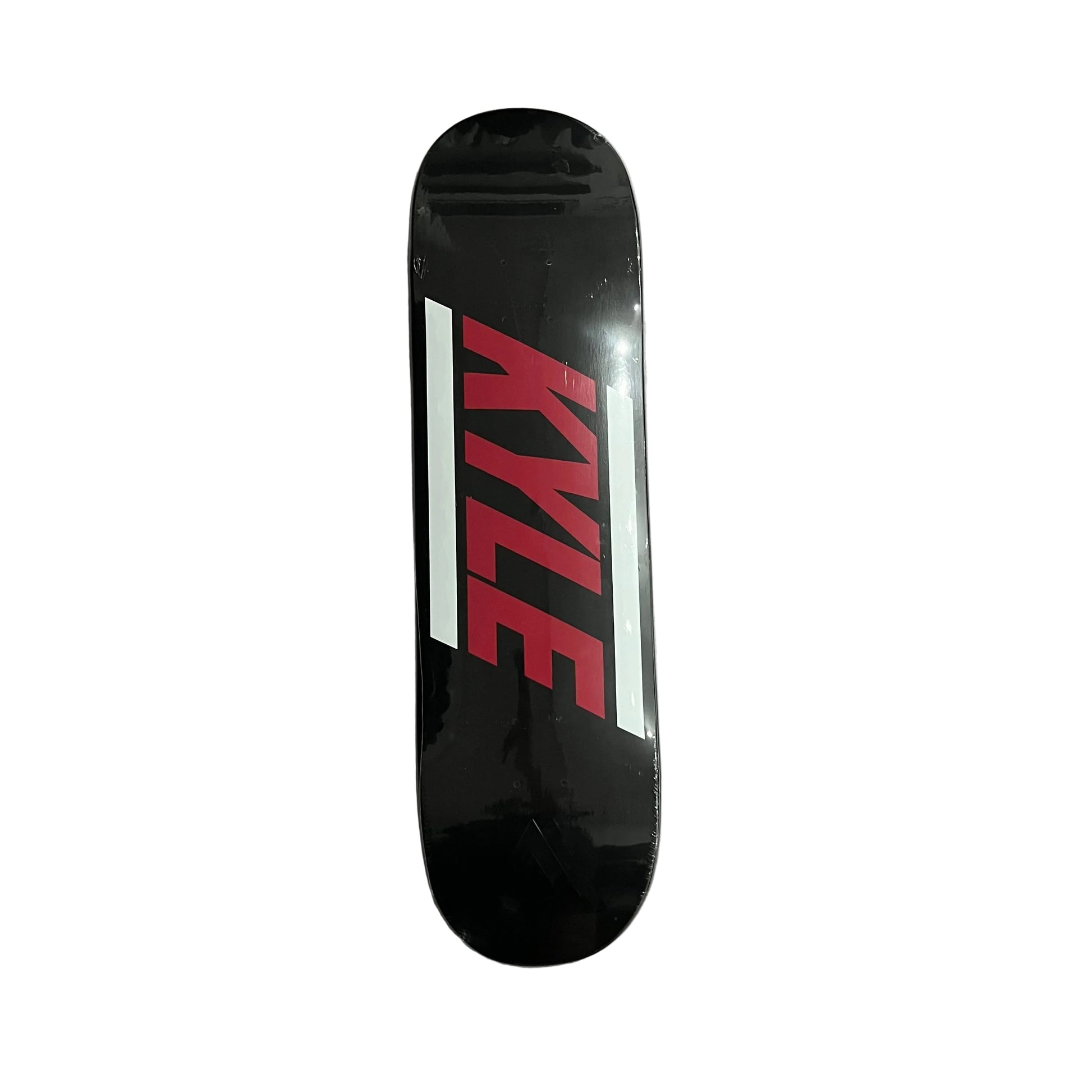 A black skateboard deck with a bold red and white 'KYLE' graphic, photographed from directly above on a white surface.