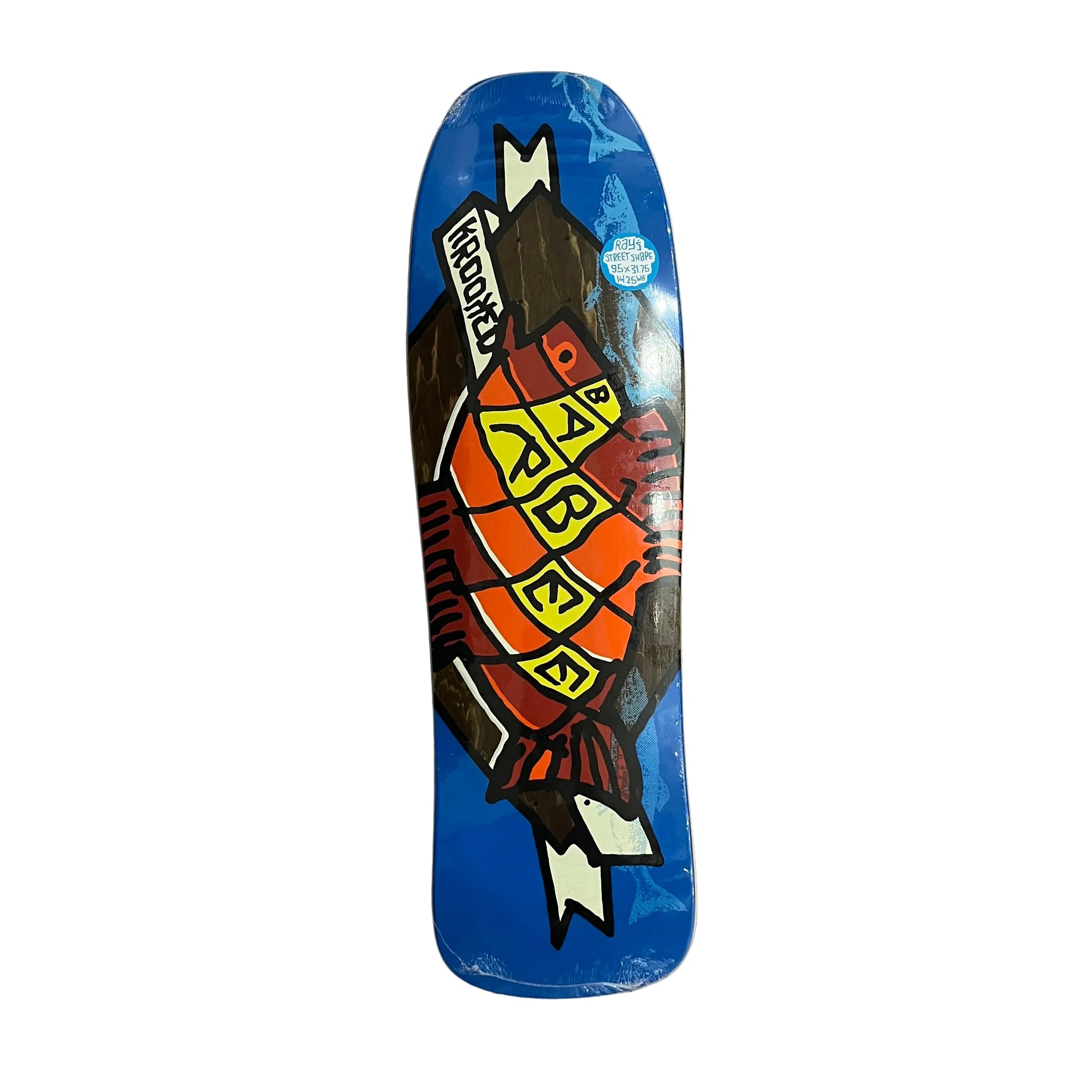 A skateboard deck with a blue background and a graphic of a fish labeled 'BARBEE' and 'KROOKED', placed on a white surface.