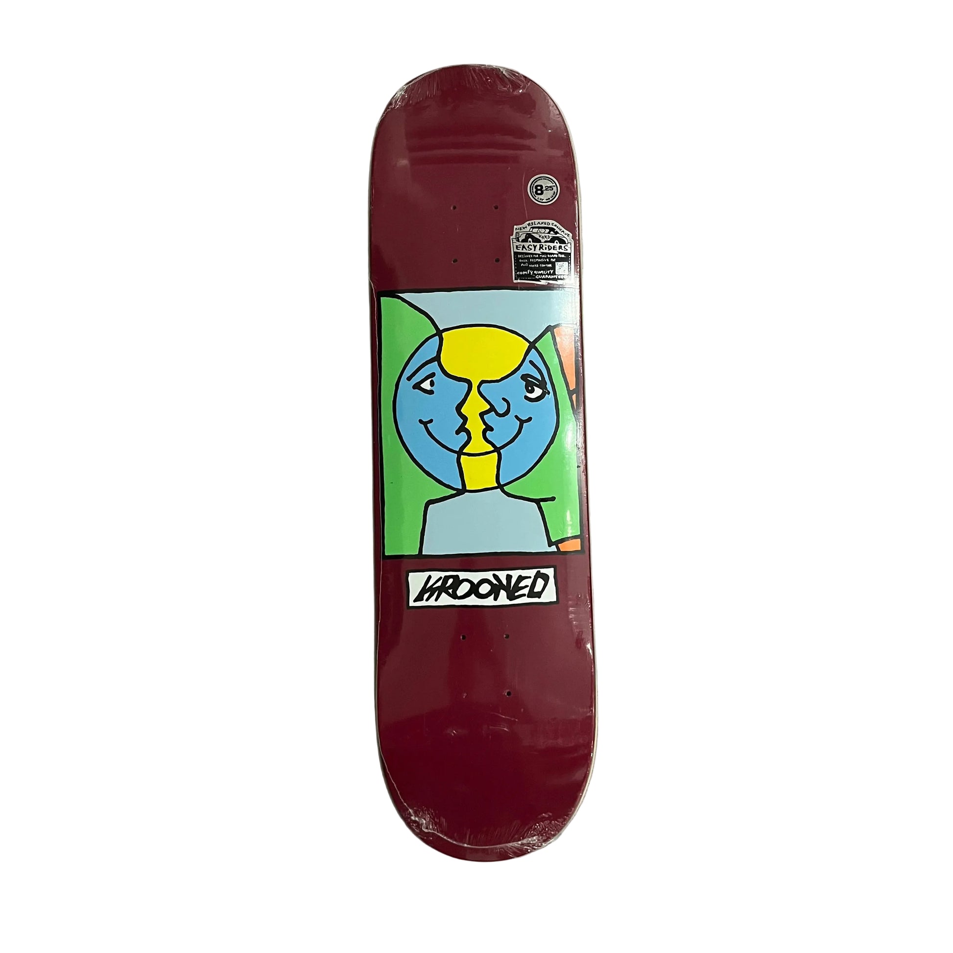 A skateboard deck with a dark red base and a colorful graphic of two split faces, resting on a white surface.