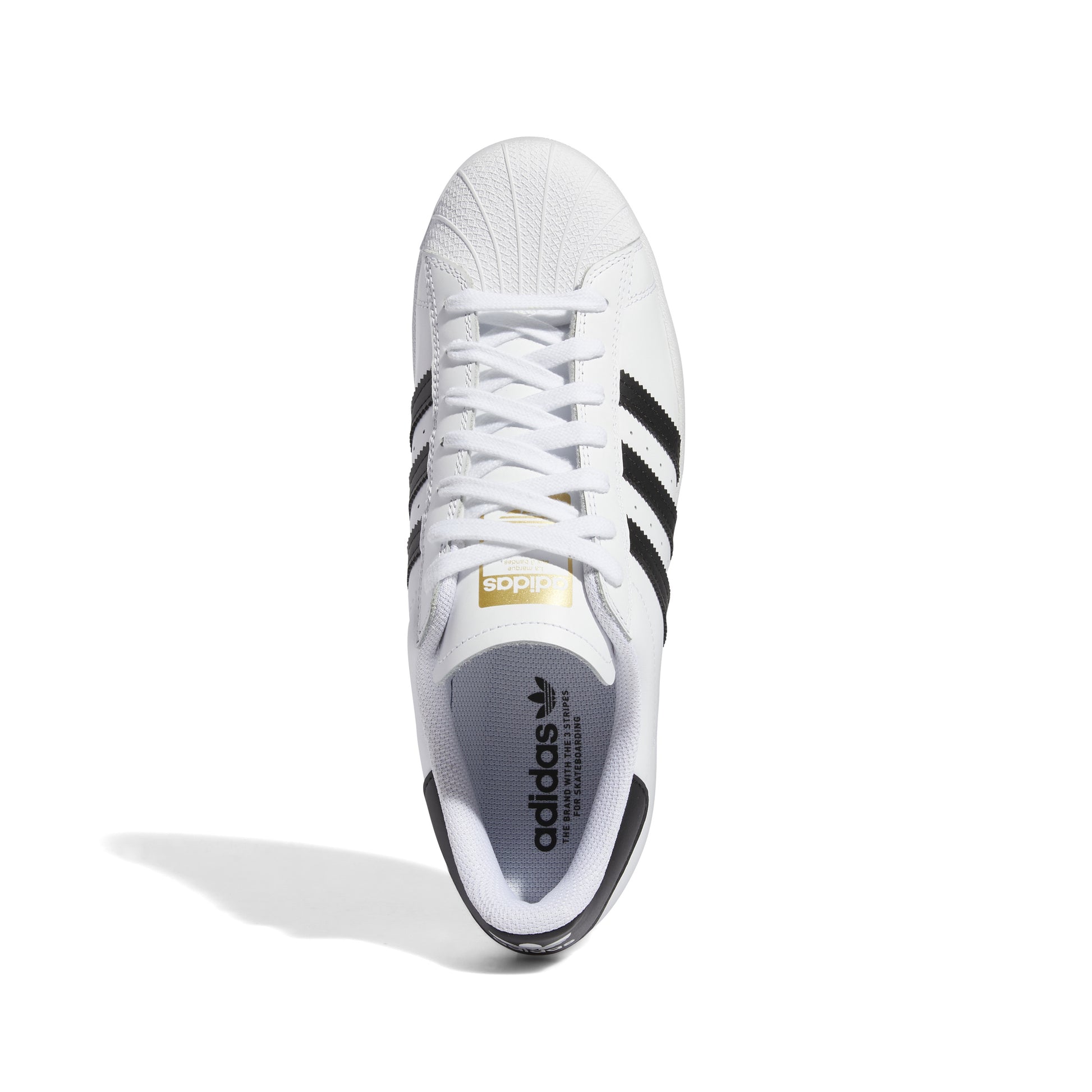top down view of white leather lowtop skatebaord sneaker with black stripes and black heel tab
