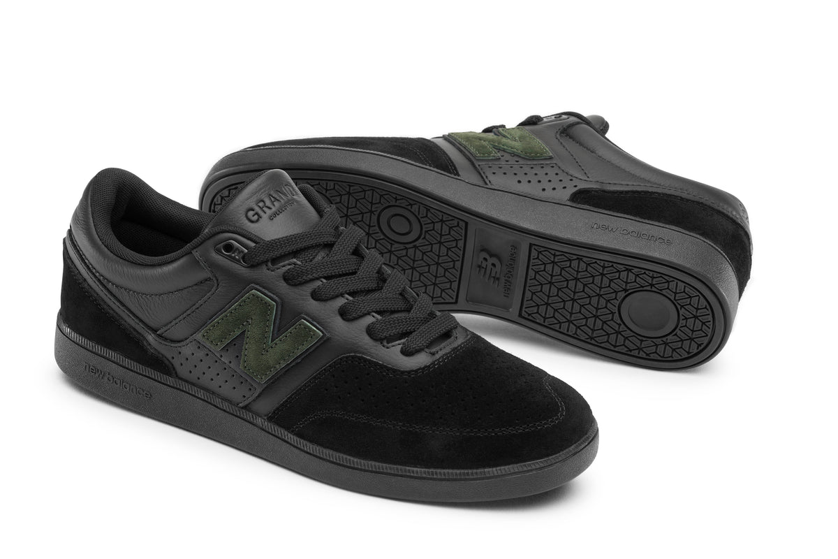 A pair of New Balance 508 sneakers in black suede and leather with olive green 'N' logos, shown on a clean white background.