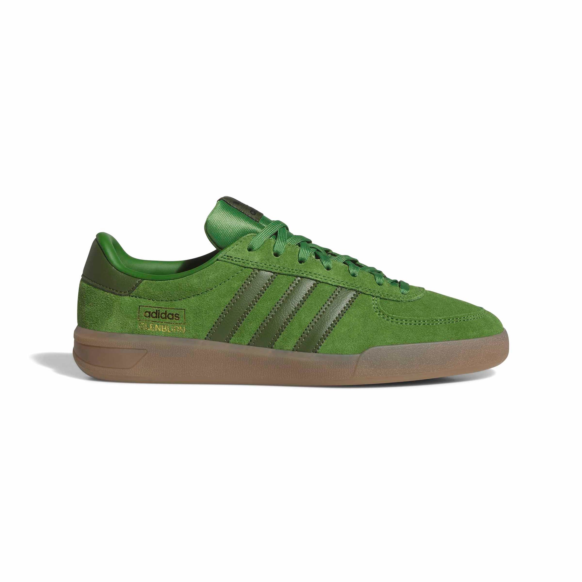 green suede soccer style shoe on white background