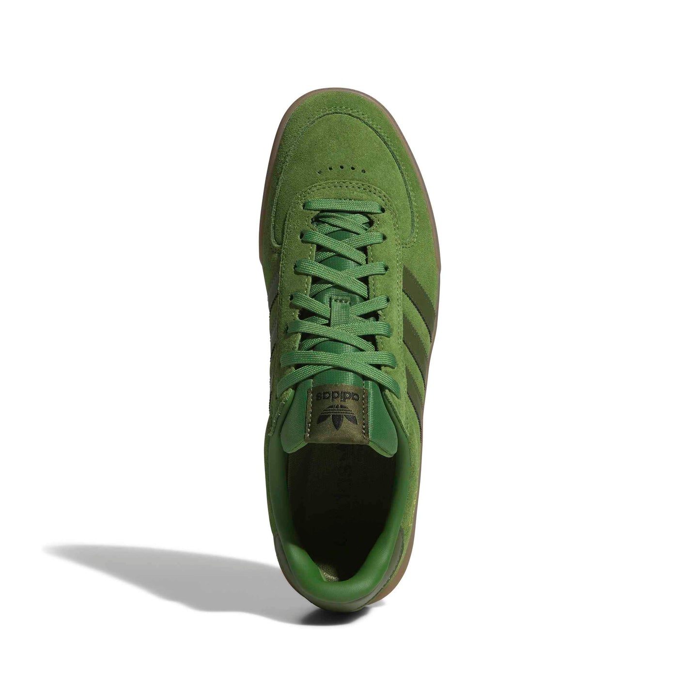 top down view of Green suede Adidas sneaker on a white background