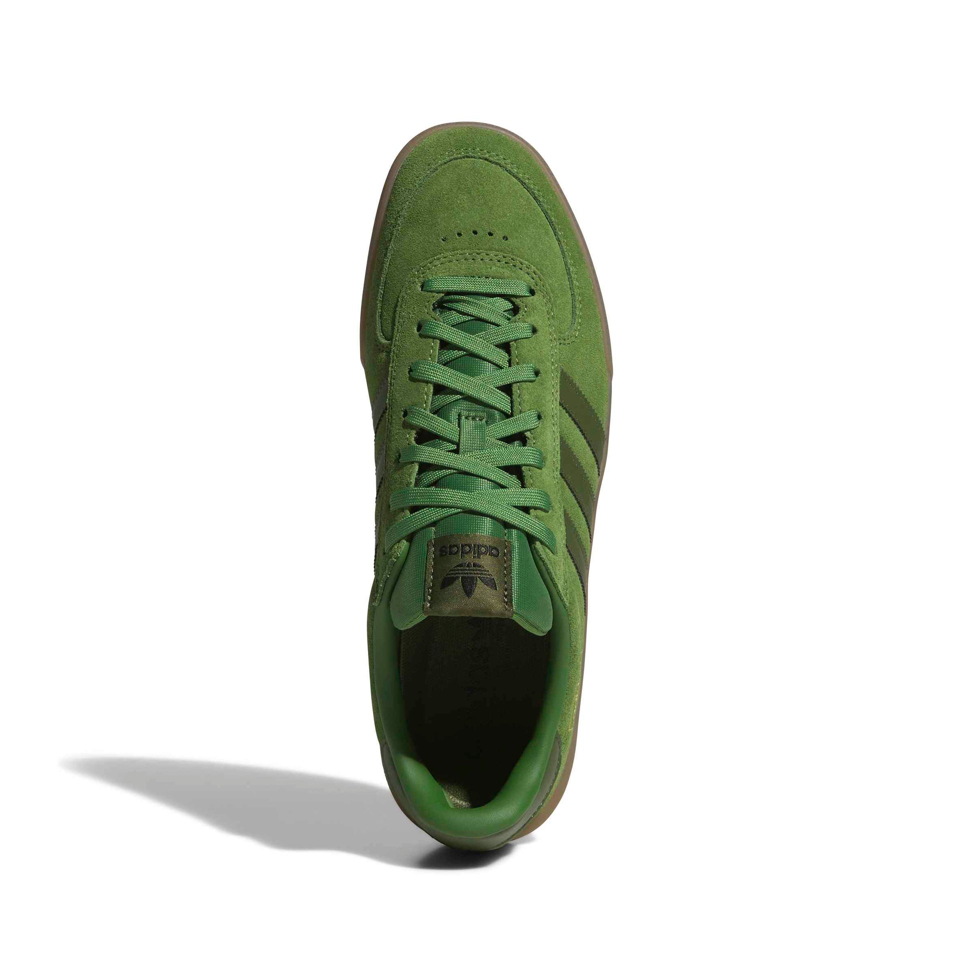 top down view of Green suede Adidas sneaker on a white background