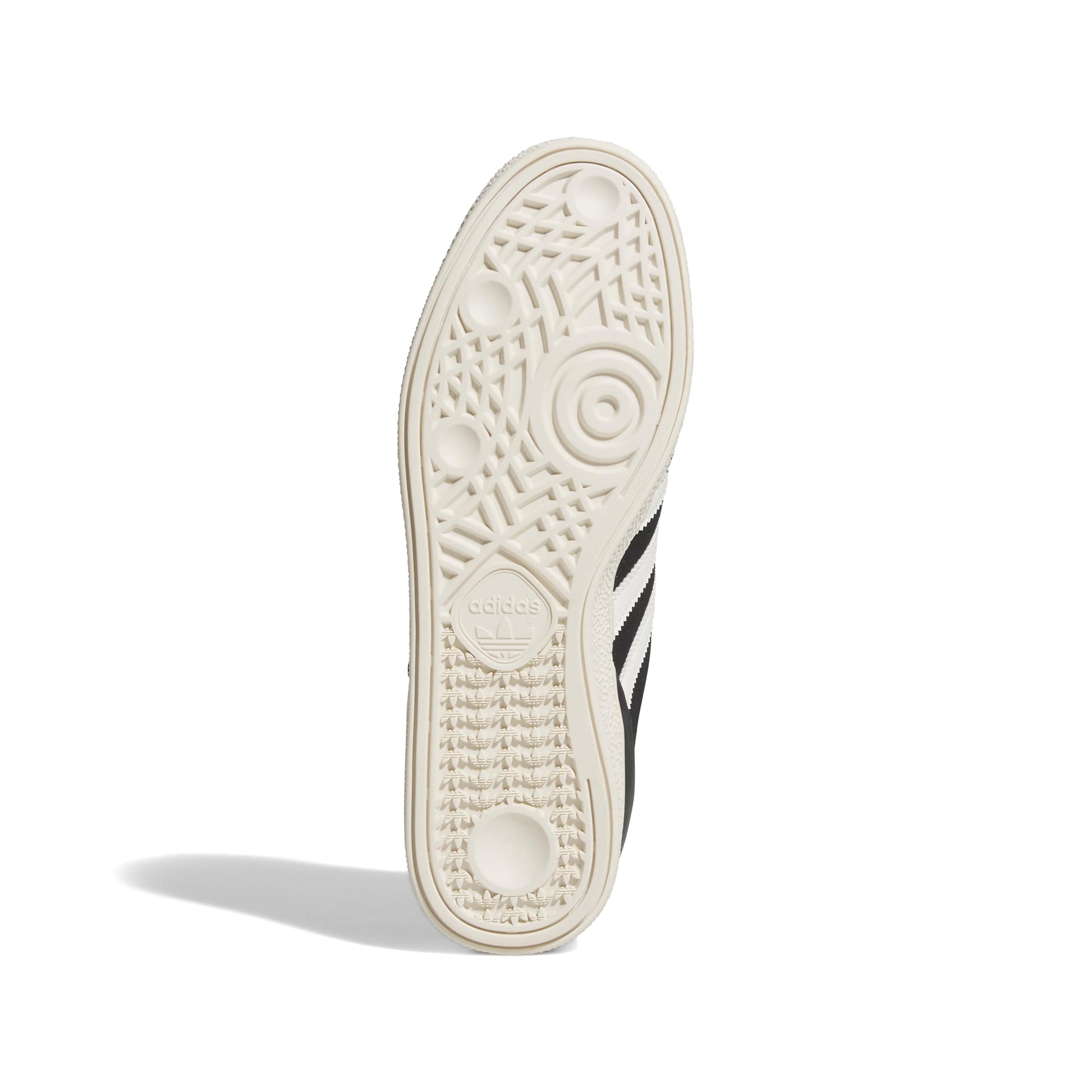 Close-up of a sneaker sole with Adidas logo and stripes on a white background