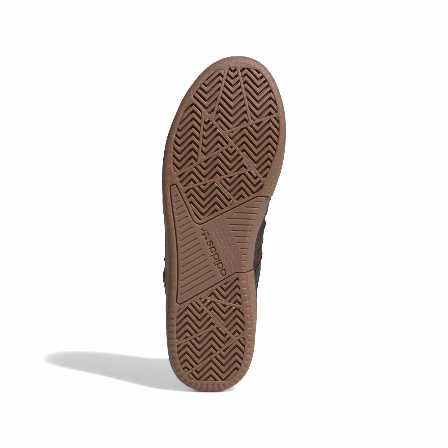 Close-up of a brown shoe sole with Adidas logo on a white background
