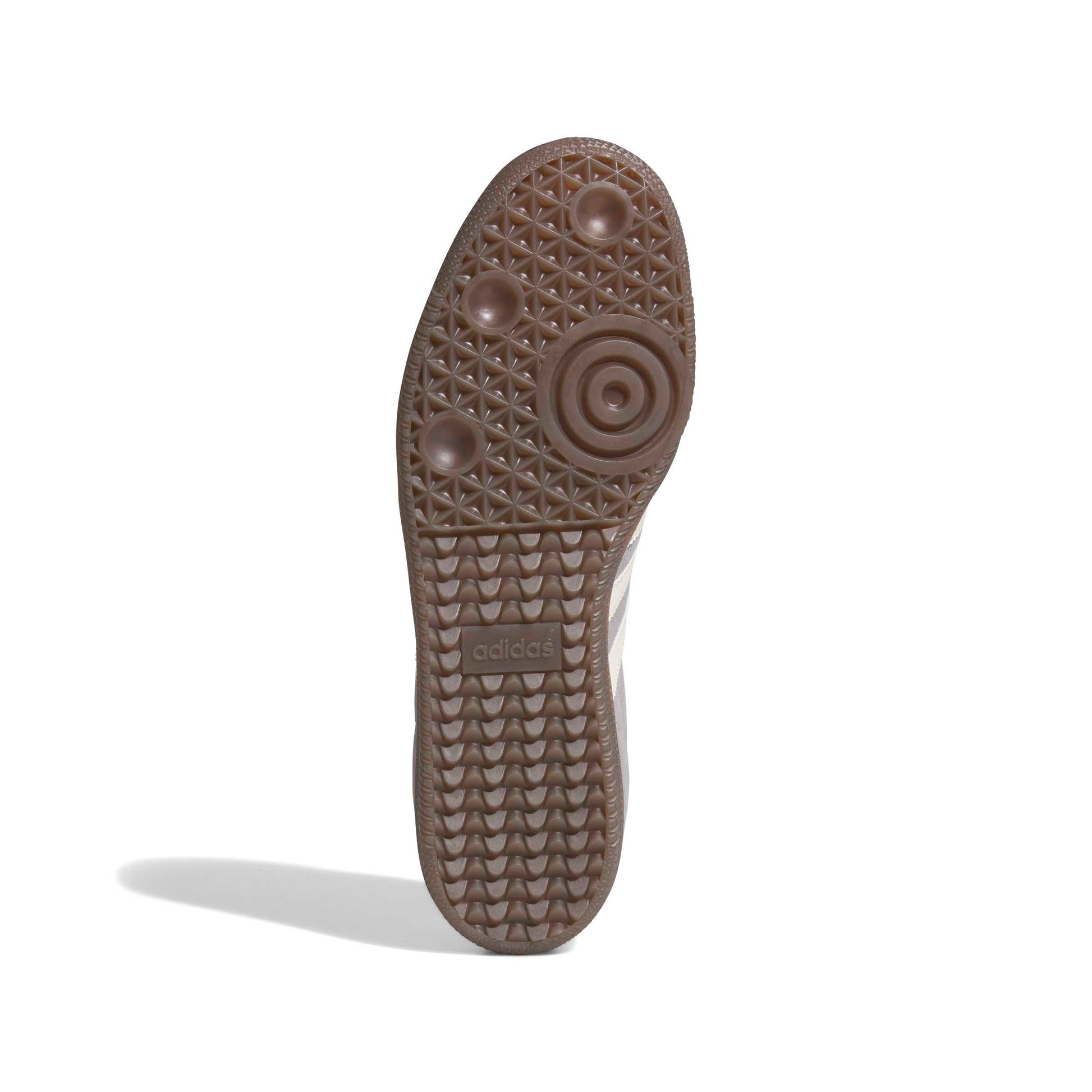Close-up of a brown shoe sole with tread pattern on a white background