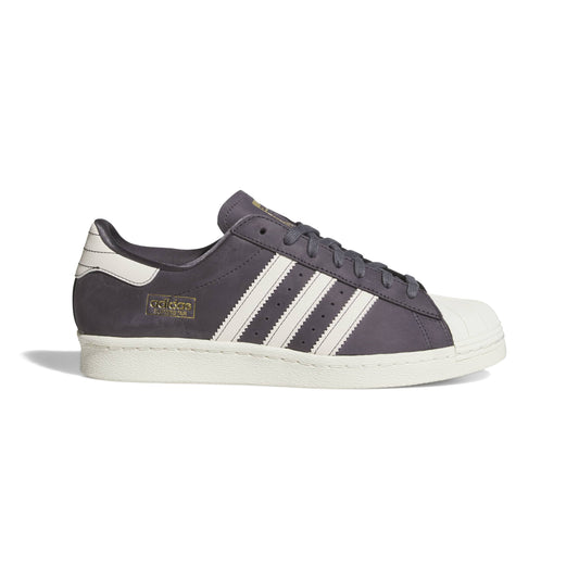 Dark gray Adidas sneaker with white stripes on a white background