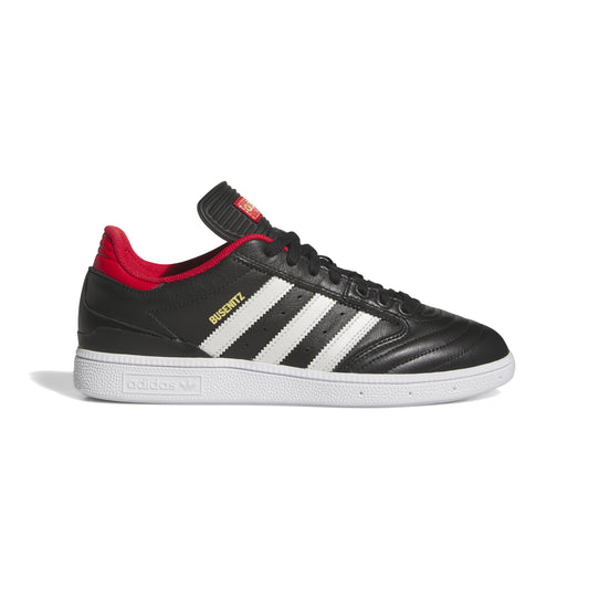 side view of black and leather soccer style skateboard shoe with white three stripes, red accent on sockliner, and white sole