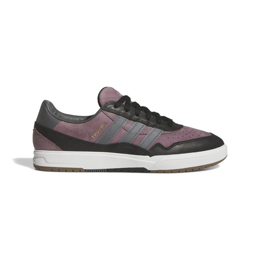 Side view of black, purple and white lowtop skateboard sneaker with three black stripes