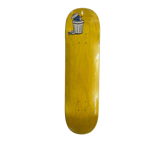 A yellow skateboard deck with a cartoon trash can graphic near the nose, photographed flat on a white surface.