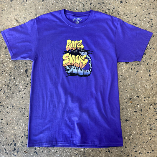 purple t shirt with yellow/orange text with a train coming out of a crack in the ground