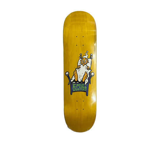 A yellow skateboard deck with a graphic of a white and orange character wearing a hat and sitting on a bed, displayed on a white surface.