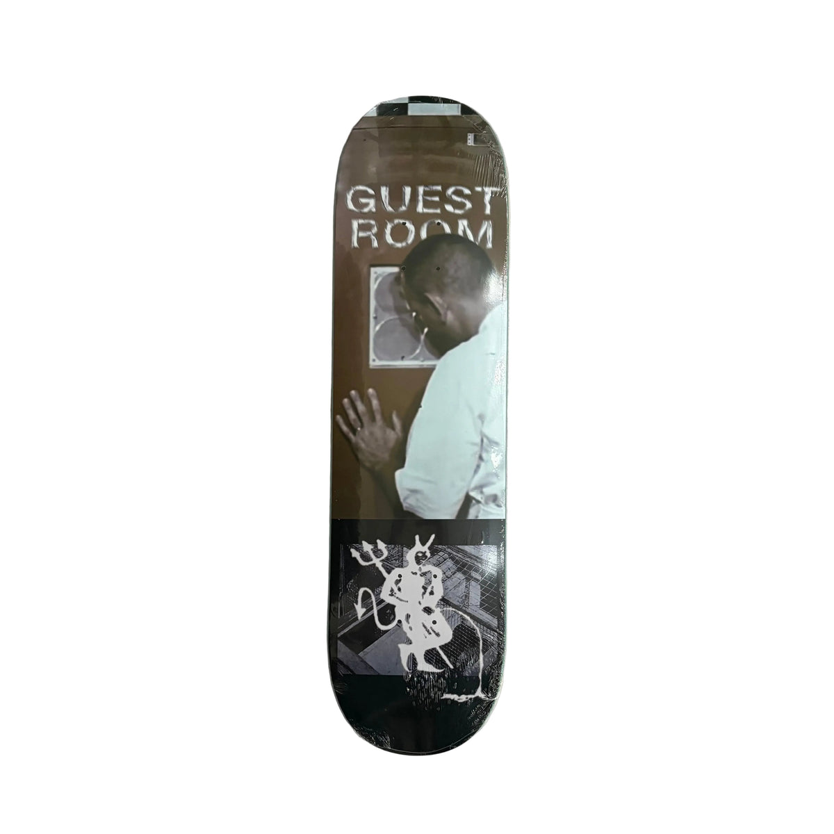 A skateboard deck with a graphic print featuring the text 'GUEST ROOM' and a photo of a man, displayed on a white surface