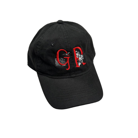 A black baseball cap with red and white embroidered lettering on the front, resting on a white surface.