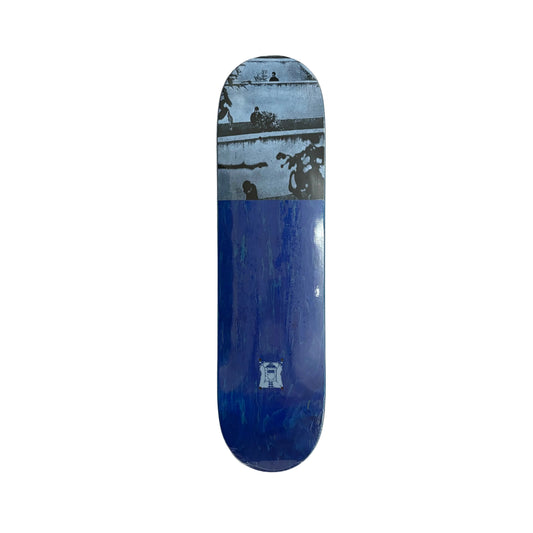 A skateboard deck with a blue and white graphic print, displayed vertically on a white surface