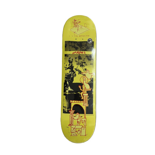 A collage style skateboard deck with a bright yellow background and a black graphic illustration, photographed from above on a white background