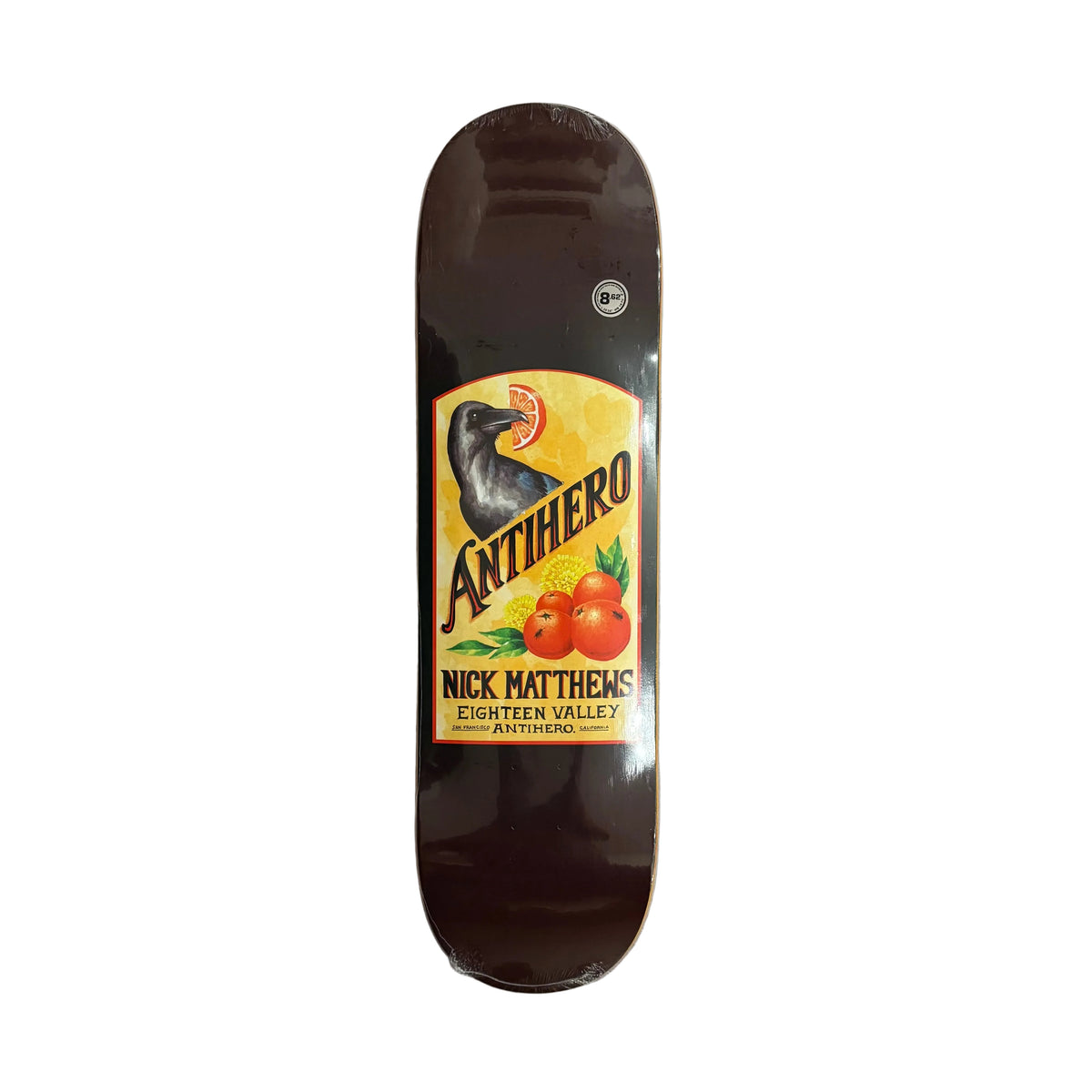 A dark brown skateboard deck featuring a prominent vintage-style Anthero 'Nick Matthews Eighteen Valley Antihero' graphic, shown flat on a white background