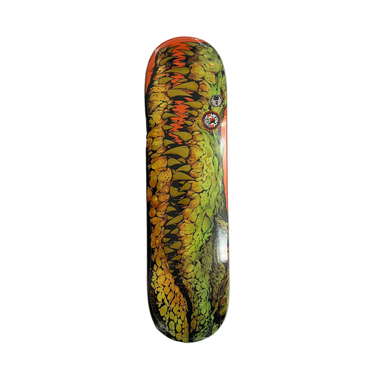 A skateboard deck featuring a detailed illustration of a green alligator with yellow and orange scales, resting on a white background