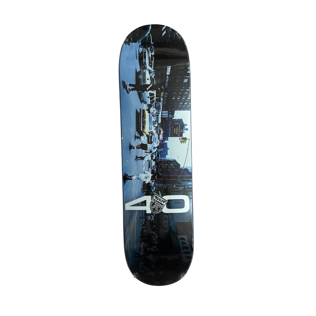 A skateboard deck with a New York City skyline graphic, featuring a large white '40' logo near the bottom, displayed vertically on a white background.