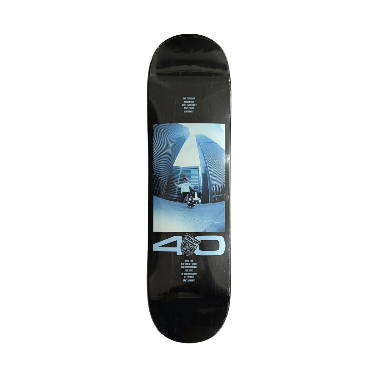 A black skateboard deck with a graphic print featuring a skateboarder in a skatepark and the text '40' in light blue, displayed vertically on a white surface