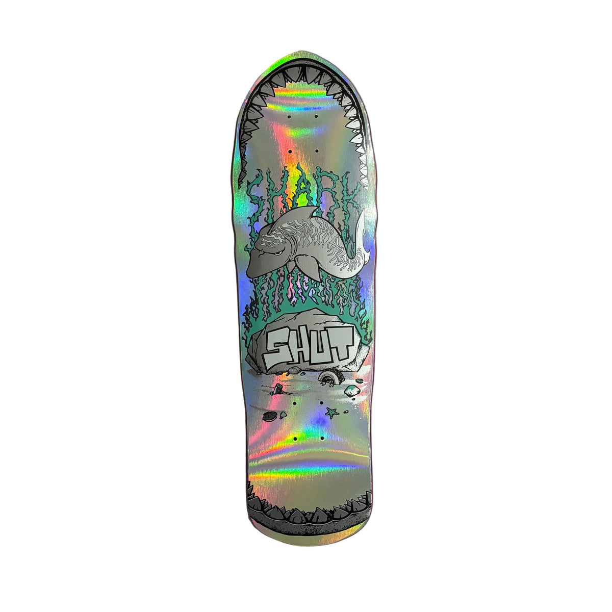 A skateboard deck with a highly reflective holographic finish, featuring a shark mouth graphic with flames and the word 'SHUT' in stylized lettering, displayed on a white background.