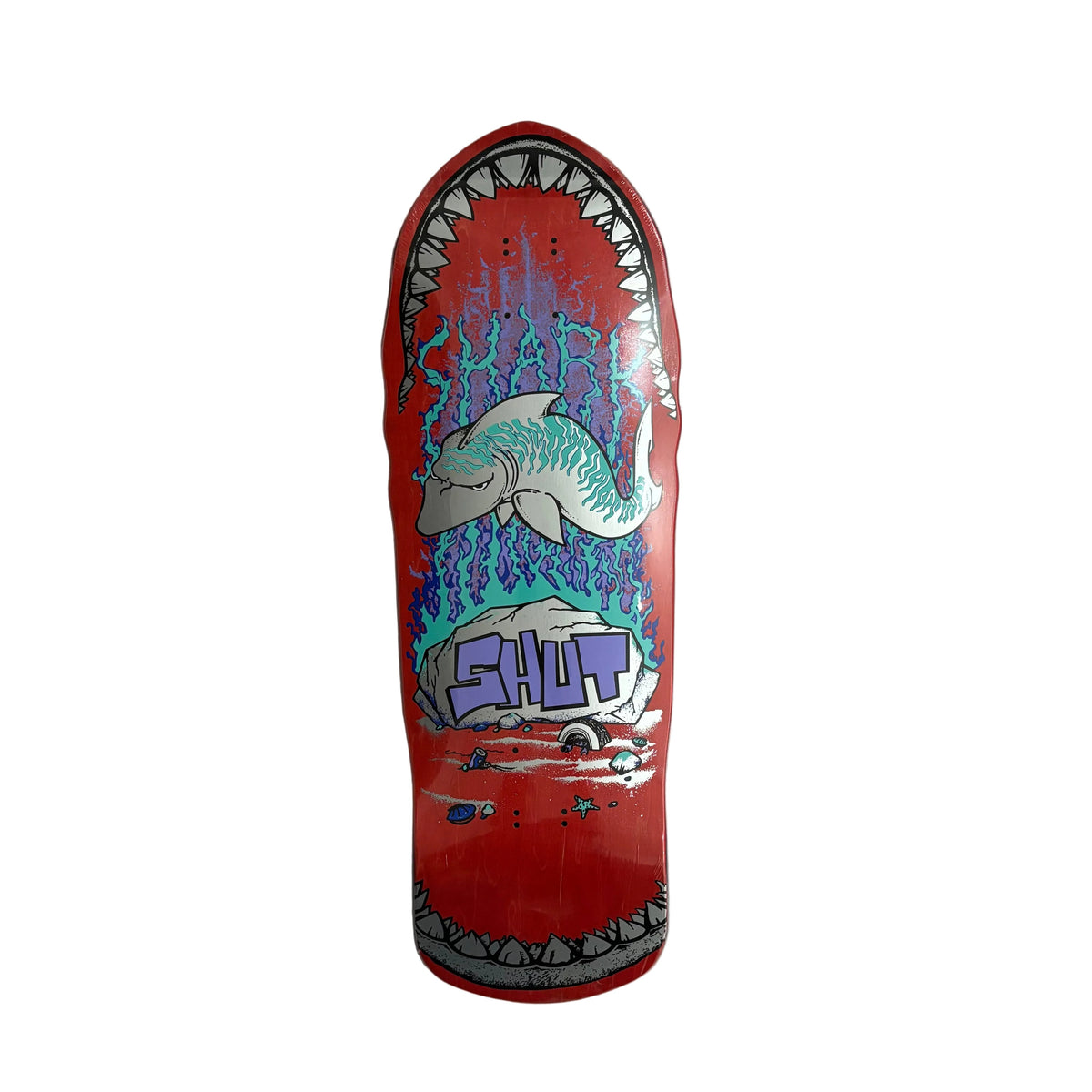 A red skateboard deck featuring a graphic of a shark inside an open mouth with blue water splashes and the word 'SHUT' in purple, displayed against a white background