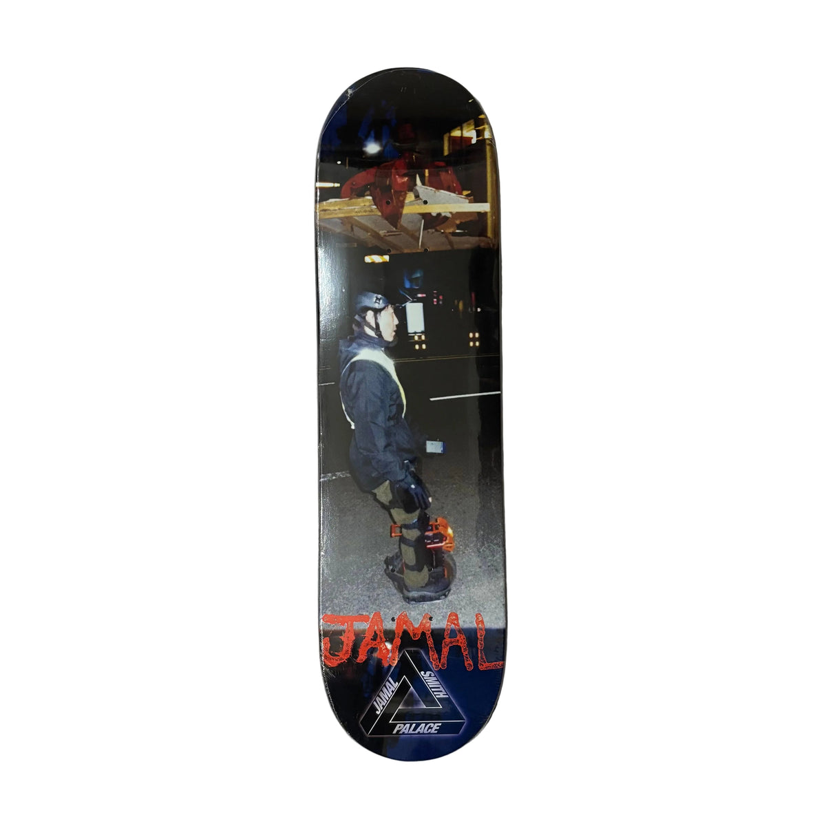 A skateboard deck featuring a graphic print of a person in protective gear on a street at night, with the name 'JAMAL' in red and a triangular logo for 'AXE' at the bottom, displayed on a white surface.