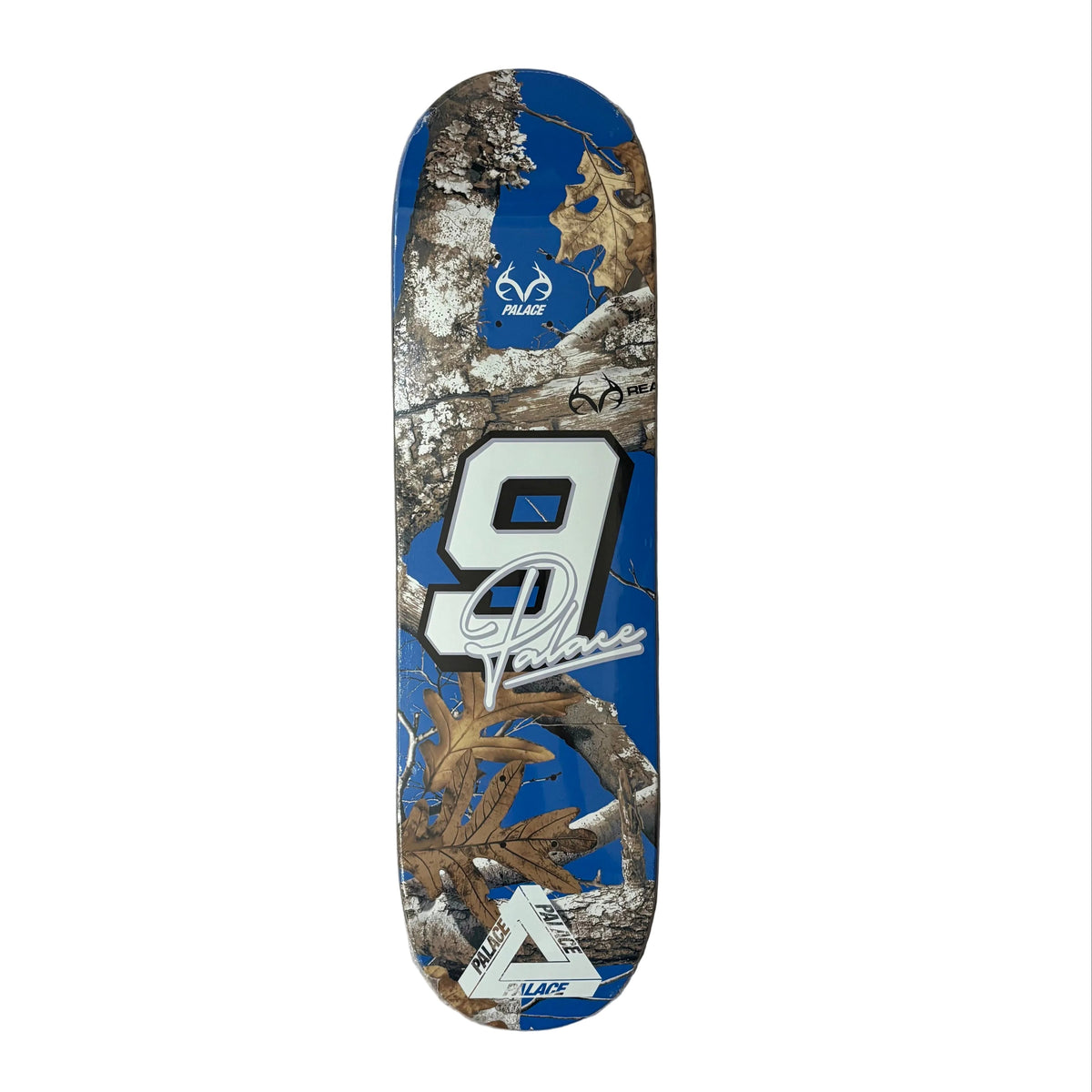 A custom skateboard deck featuring a blue background with a large white number 9, a Realtree camouflage tree branch graphic, and a white stylized 'V' logo at the bottom, displayed on a white surface