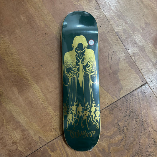 green skateboard deck with gold puppetmaster graphic