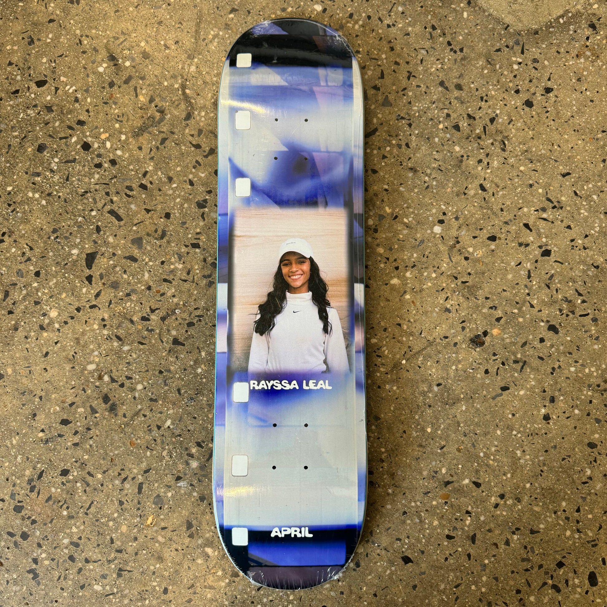 purple white gradient skateboard deck with a photo of a young girl in the center