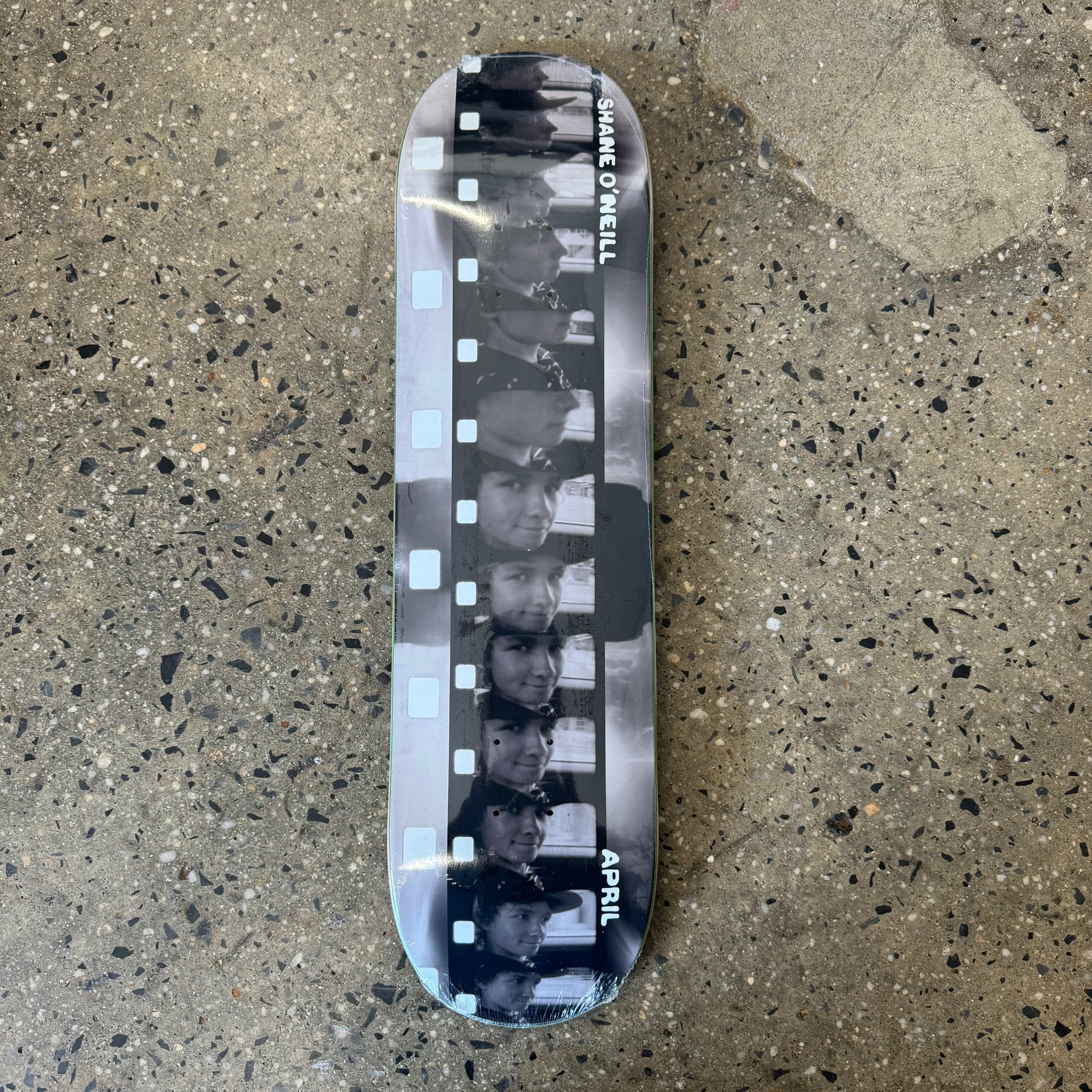 black, white grey gradient skateboard deck with film photo in the center