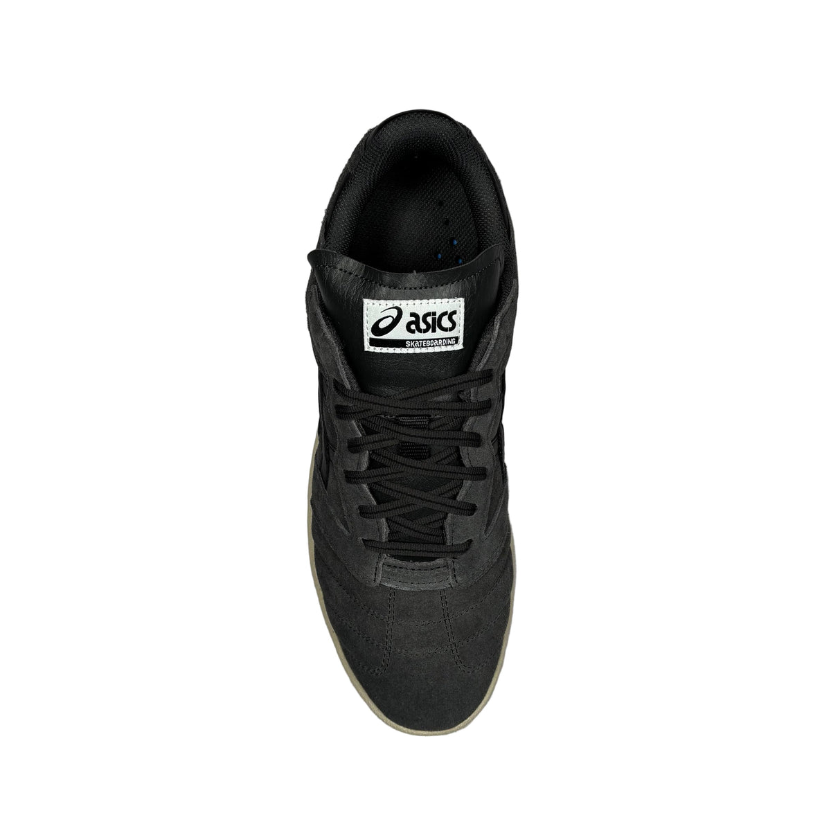 A single black ASICS sneaker shown from a top-down view on a textured gray concrete surface. The shoe features black laces, a black tongue label with the white ASICS logo, and a light beige gum outsole.