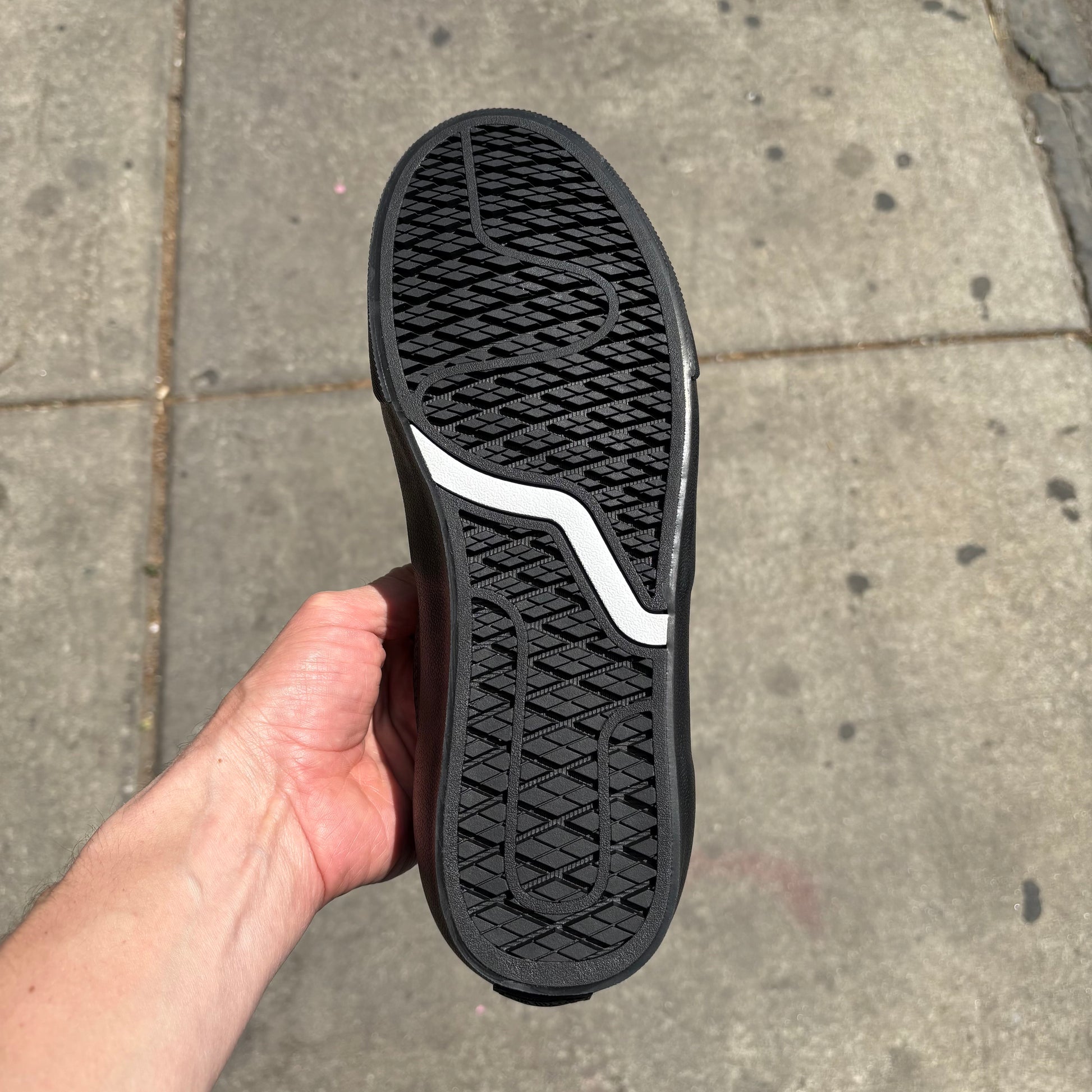 view of vans outsole on black leather low top skateboard sneaker