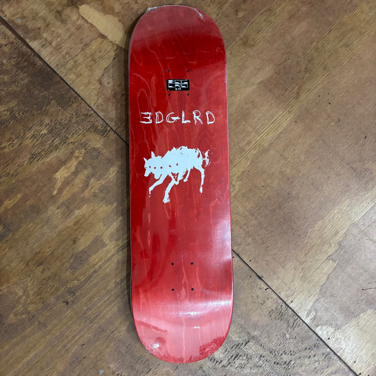 red woodgrain deck with white three headed wolf printed in the middle