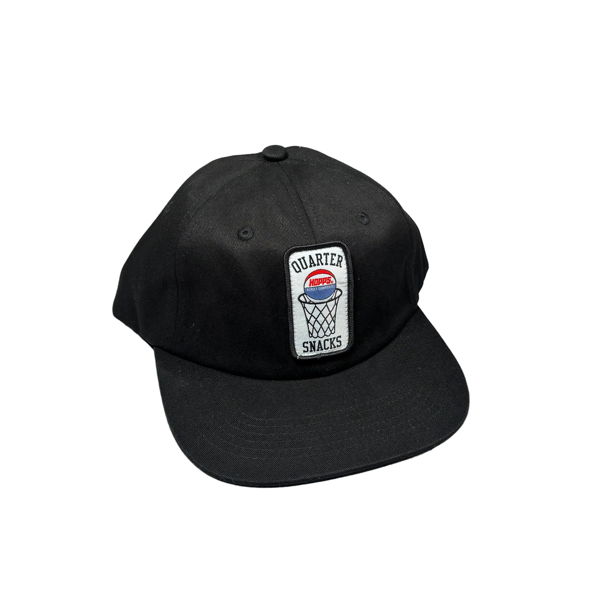 A black flat-brim baseball cap with a rectangular embroidered patch on the front that reads 'QUARTER SNACKS' around a basketball graphic. The cap is placed on a white background.
